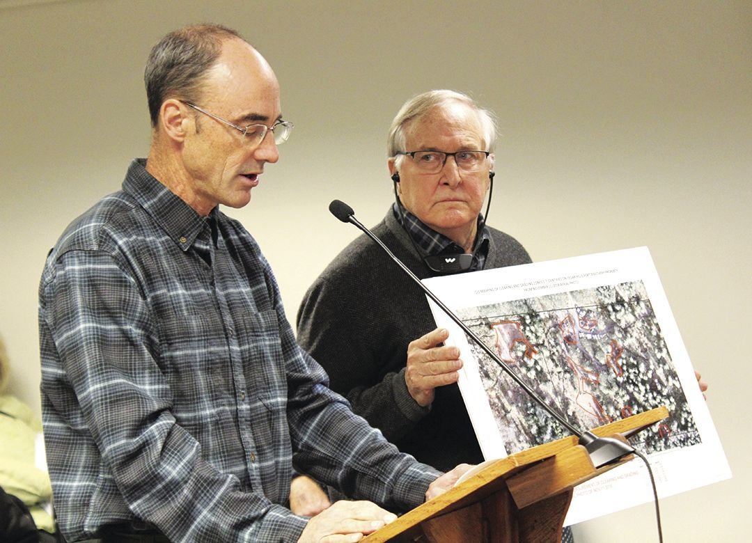 Peter Bahls, executive cirector of the Northwest Watershed Institute, explains his process in determining the possible code violations at the Cedar Hills Recreational Facility, while Tarboo Ridge Coalition Board President Peter Newland holds up a map to demonstrate to the Board of County Commissioners at their meeting Nov. 19. 
