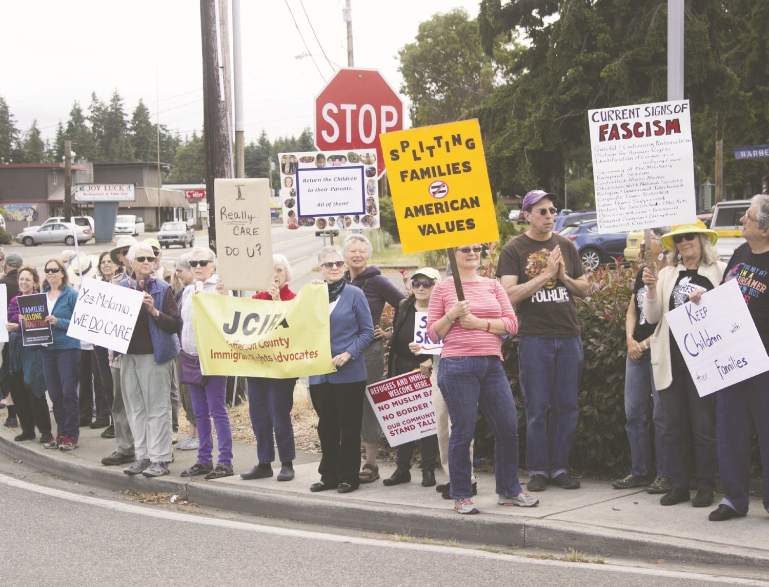 More than 250 protesters throng the intersection of Highway 116 and Irondale Road in Port Hadlock June 22, to express their objections to the Trump administration's policies toward detaining illegal migrant families.