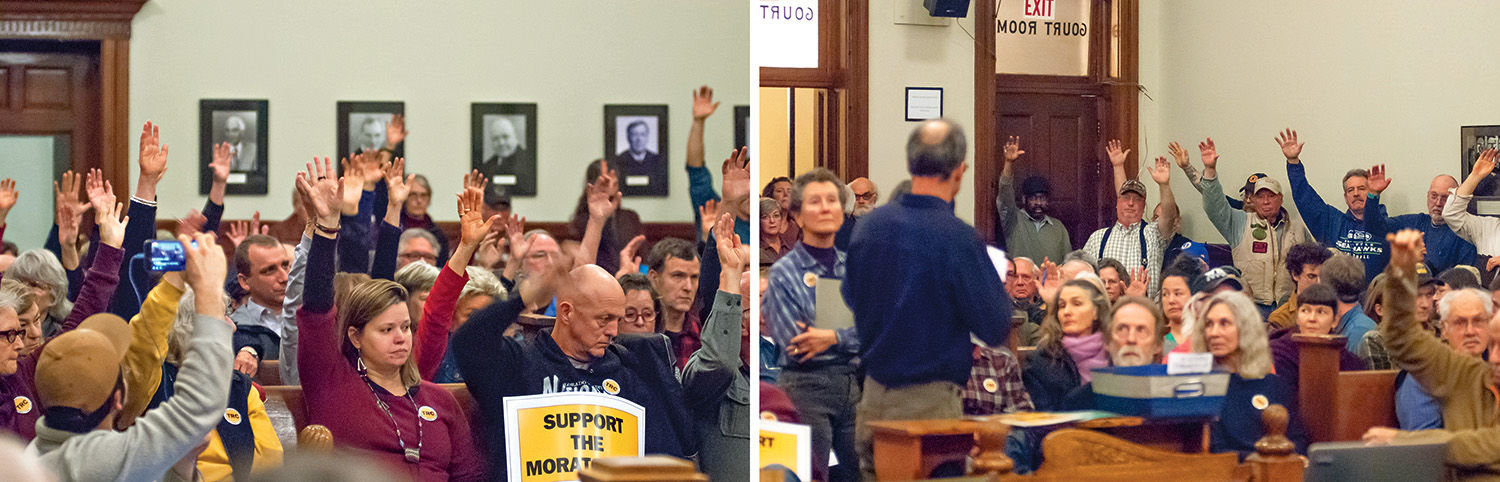 People raise their hands Feb. 5 to show their support for a one-year moratorium, left, as well as against it. Photos by Chris Tucker