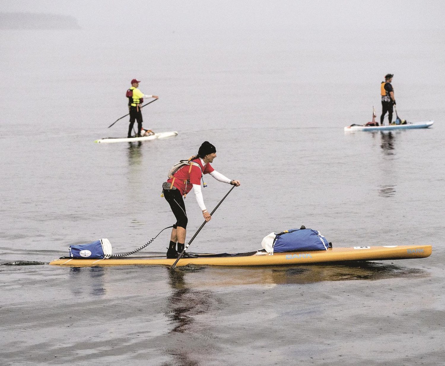 Stand-up paddleboarders, including Karl Kruger of Orcas Island (foreground), started out in June to cross the Strait of Juan de Fuca and paddle on to Victoria for the first leg of the third Race to Alaska, the 750-mile race from Port Townsend to Ketchikan, Alaska. Kruger went on to become the first person to finish the R2AK race on a stand-up paddleboard.