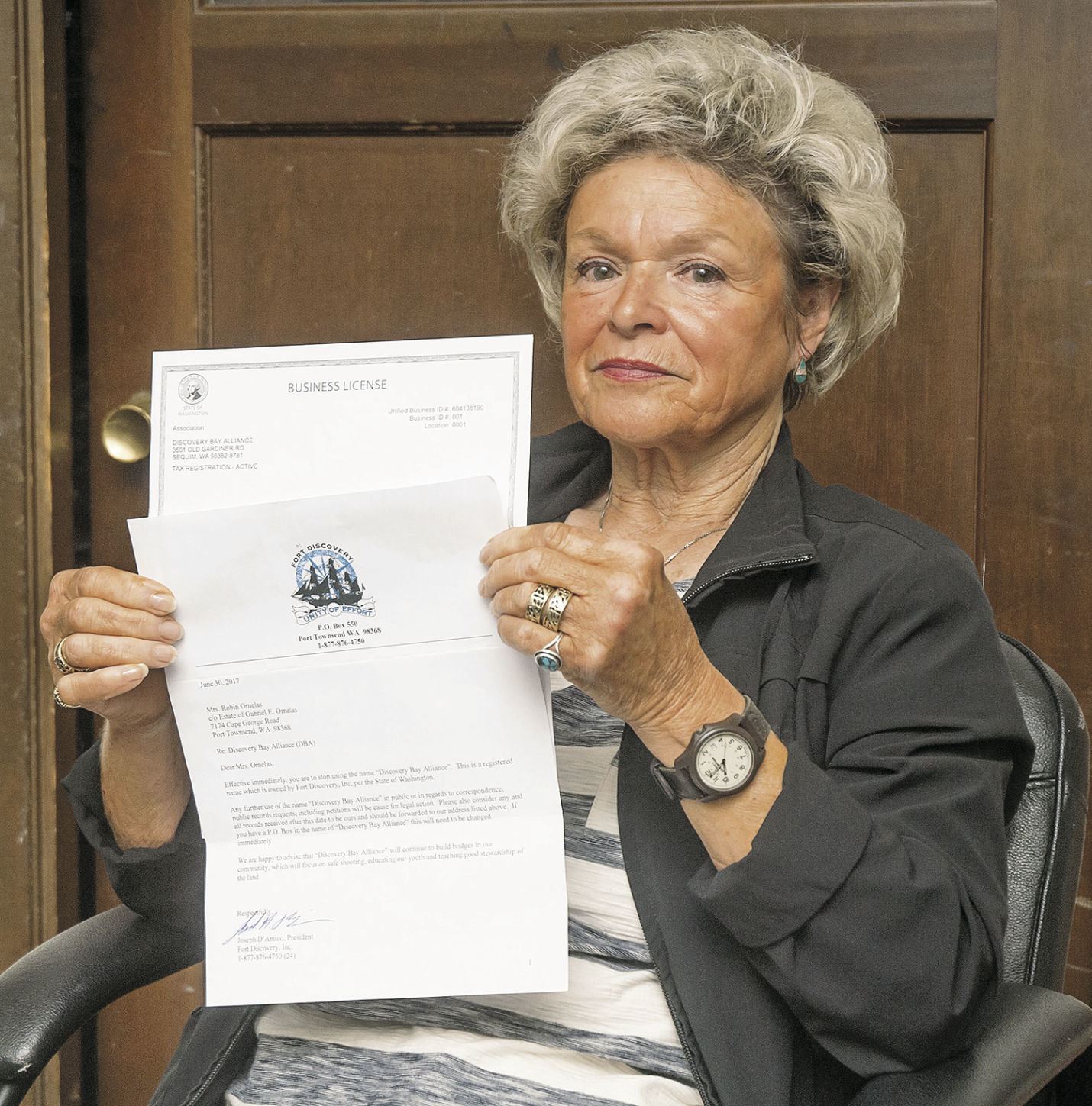 Robin Ornelas holds a copy of the letter that Joe D’Amico handed to her July 10 telling her to stop using the name Discovery Bay Alliance. That name has been used since 2005 by a group petitioning Jefferson County to take action on D’Amico’s business for what the group deems is action by the business that runs contrary to a decision by a hearings examiner on land use. Photo by Chris Tucker