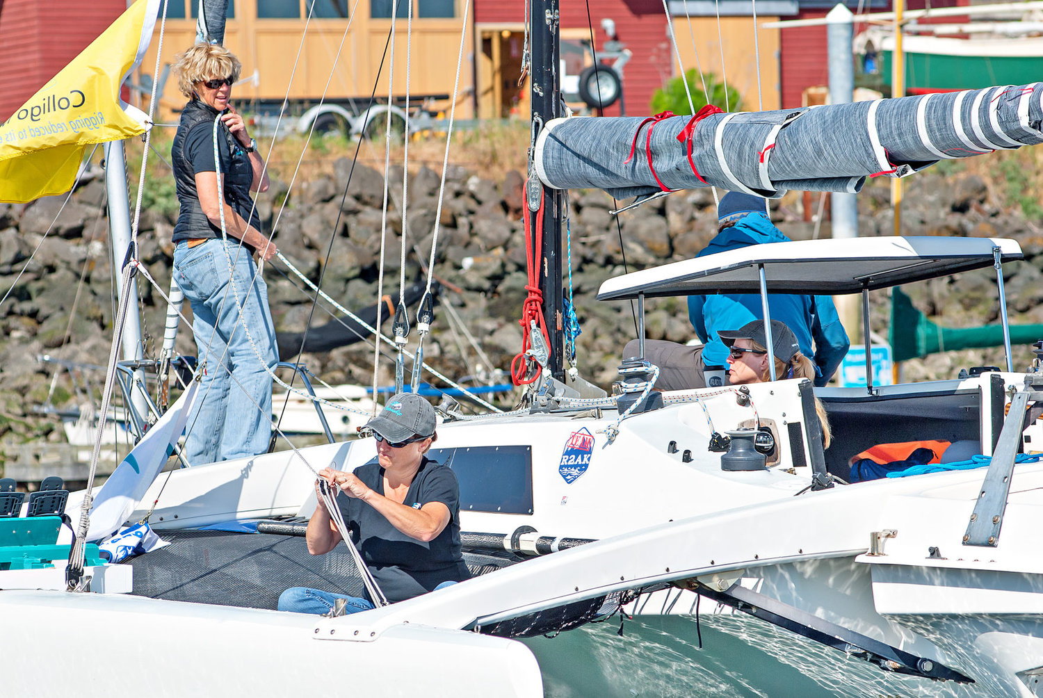 Race to Alaska competitors (from left) Michelle Boroski, Stephanie Maheu and Stephanie York prepare their Corsair F-27 trimaran at the Point Hudson Marina on Tuesday, June 6. The women, along with Johanna Gabbard, are with the Ventura, California–based all-female “Team Sistership.” Boroski, the captain, said they completed the race last year and are trying to improve their time this year. They also raised $8,000 in Northwest Maritime scholarships for women and girls. In the blue jacket is Bob Downes with Brion Toss Yacht Riggers. Boroski lived in Port Townsend for 10 years prior to moving to Ventura and said the team was “way more prepared than we were last year.” Learn more at sistership.org. Photo by Chris Tucker