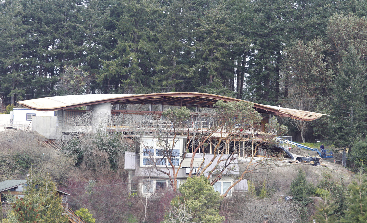 With its uniquely shaped roof, this 6,870-square-foot residence under construction on Morgan Hill’s south side is getting people’s attention. This is a view looking north from the Port Townsend High School campus. Photo by Patrick Sullivan