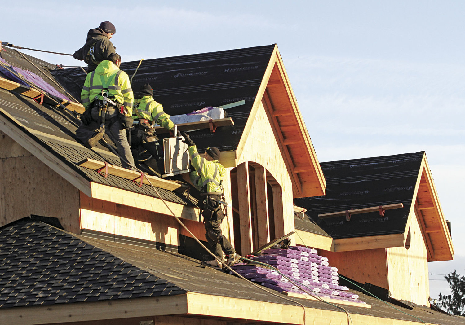 A crew from All Weather Roofing works on a home under construction in uptown Port Townsend. Housing projects picked up considerably in 2016, and the City of Port Townsend is gearing up for a substantial increase in permits and planning for housing projects, big and small, in 2017 and 2018. Photo by Patrick Sullivan