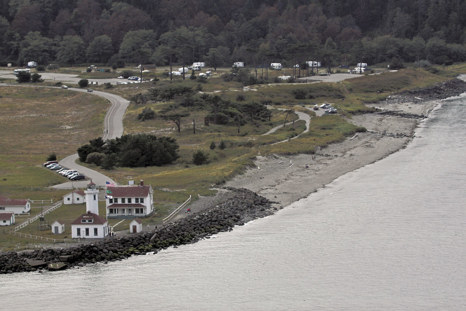 This 2010 view of Point Wilson shows how the rock riprap, added to the point in 2005, has changed; a beach dune has been worn down and has a trail going over it, but it’s still mostly intact. 2010 Leader file photo by Patrick Sullivan