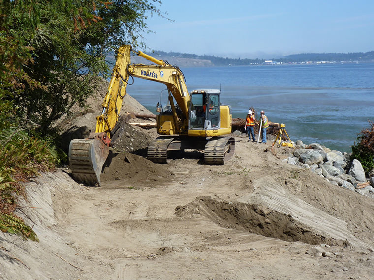 An excavator removes rocks that had been used to armor the beach at Fort Townsend State Park along Port Townsend Bay, as part of a shoreline enhancement project taking place through mid-August. Courtesy photo