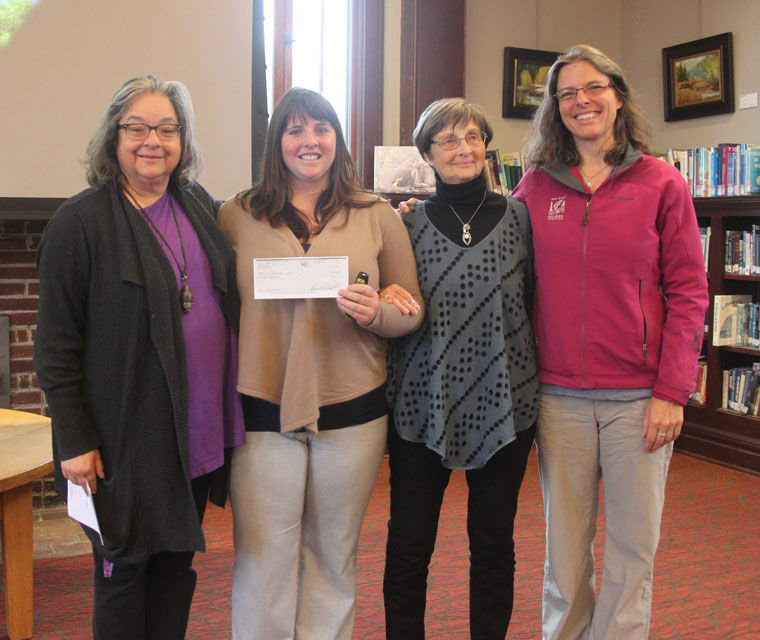 Mara Lathrop (left) of the Jefferson County Community Foundation's Giving Circle 3 presents a check for $20,000 to Sarah Doyle, stewardship coordinator for North Olympic Salmon Coalition (NOSC), on May 18, with Grace Dumenil and Rebecca Benjamin. Funds go toward incorporating climate-change classes into the middle school curriculum and supporting a native plant nursery and tree-planting program. Photo by Robin Dudley