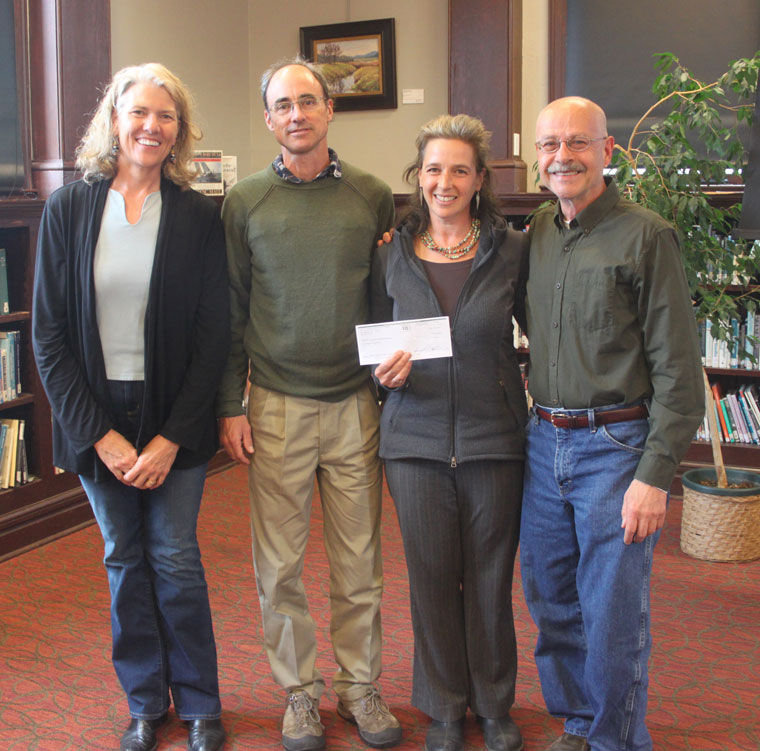 On behalf of the Northwest Watershed Institute, (from left) Liz Hoenig Kanieski, Peter Bahls and Jude Rubin accept a check for $10,000 from Francesco Tortorici of Jefferson County Community Foundation's Better Living Through Giving Circle on May 18. The funds are to help launch the Olympic Youth Environmental Stewardship (YES) Leadership Program, a new accredited class for local high school students. Photo by Robin Dudley