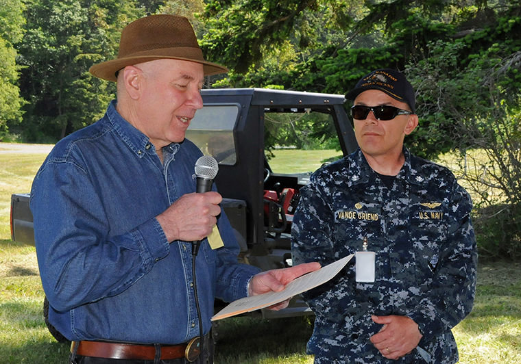Cmdr. Nicholas A. Vande Griend, U.S. Navy, commanding officer of Naval Magazine Indian Island (right), listens as Jefferson County Commissioner David Sullivan reads a formal proclamation in recognition of the 75th anniversary of Naval Magazine Indian Island’s establishment. Courtesy U.S. Navy photo by Phil Guerrero