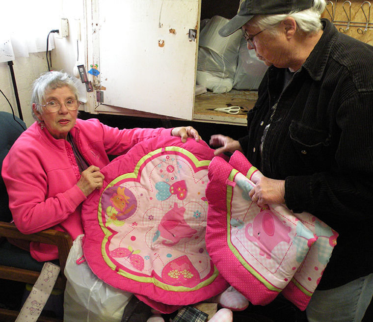 Sarah Klause (seated, left) has been helping sort donations at the Adventist Thrift Shop in Port Townsend’s Uptown District since 1999. She says that a lot of wonderful items, like the pink baby mats above, are donated. Manager Fran Carey (right) says the store, open from 10 a.m. to 3 p.m., Tuesday and Thursday only, typically sees 60 customers a day. The store used to be known as the “Free Store,” but it now has a price list. T-shirts cost 50 cents. People in need can get vouchers from Olympic Community Action Programs (OlyCAP) and use them like money, Carey says. Donations are accepted 24/7 these days. Photo by Allison Arthur
