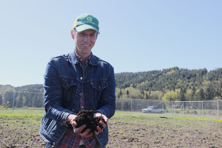 Horticulturist Kyle Craig holds soil from land where he intends to grow marijuana for use by local processors. He's also planning experiments to see what varieties grow well in the Beaver Valley microclimate. Craig would like to be certified as organic, but because that entails a federal designation, it's not possible now. Photo by Allison Arthur