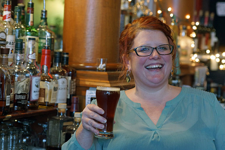 Amber Bartl holds a Scotch ale from Port Townsend Brewing Company while working at The Old Whiskey Mill recently in Port Townsend. Photo by Nicholas Johnson