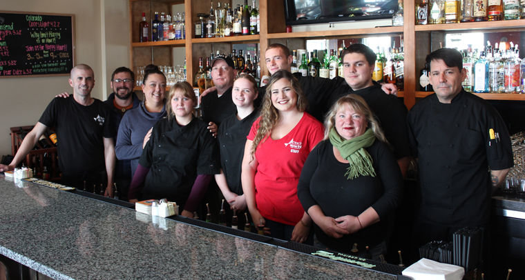 Doc's Marina Grill employees (from left) Colin Darlington, David Lindsay, manager Teresa Schultz, Emily Smith, Kevin King, Denelle Linner, Scotty Mayberry, Rosie Lee Young, Rebecca Lupton, Derek Conover, and chef Rafael Alvaraz gather behind the bar inside Port Townsend's favorite restaurant. Photo by Jen Clark