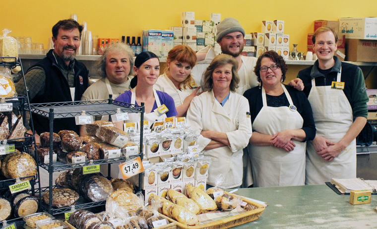 Port Townsend Food Co-op food services employees (from left) Brendan Johnson, Nicholas D’Andrea, Angela Mason, Estelle Giangrosso, Tracy Nichols, Josh Madill, Jo Holmstedt and Dylan Carter gather behind the grocery store's deli counter. Combined, they represent over 51 years of service to the Food Co-op and the Port Townsend community. Photo by Kathie Meyer