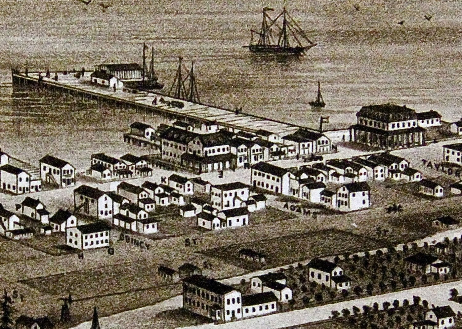 An artist's rendition of Port Townsend in 1876 shows the square, flat-topped Fowler Building on Adams St. surrounded by a wooden village. Fowler's building was the only stone structure.