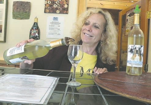 Judith Collins tends to the tasting room at Marrowstone Vineyards. A retired psychologist, Judith enjoys getting out in the vineyard to prune. The tasting room is open five days a week during the summer.