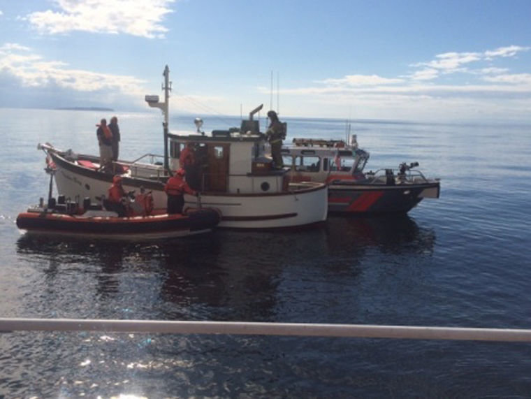 The crew of the Coast Guard Cutter Sea Fox, an 87-foot patrol boat home-ported in Bangor, and East Jefferson Fire Rescue personnel on fire boat Guardian, responded to a fire aboard a 32-foot pleasure craft outside Point Wilson, July 27, 2015. Coast Guard photo courtesy of the Coast Guard Cutter Sea Fox