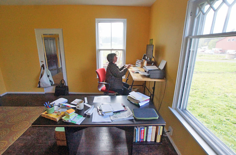 Heidi Eisenhour of the American Farmland Trust works in her new office in the FarmHouse Offices and CoLab at the historic Brown Dairy in Chimacum on April 30. Photo by Nicholas Johnson