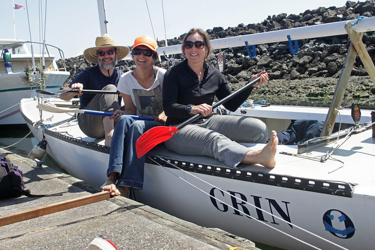 Team Grin members (from left) Jeremy Lucke, Hannah Viano and Jullie Jackson have fun while preparing their Etchells 22 for the Race to Alaska, which departs PT for Ketchikan on June 4. The Etchells 22 is named for its length at the waterline; the racing sailboat is 30 feet long overall and built for speed. Photo by Robin Dudley