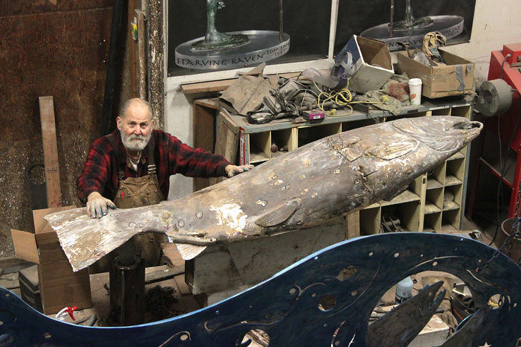 Master bronze caster Tom Jay of Chimacum is finishing a 300-pound bronze coho salmon bench for Fauntleroy’s Cove Park, a neighborhood park near the state ferry terminal in West Seattle. Photo by Robin Dudley