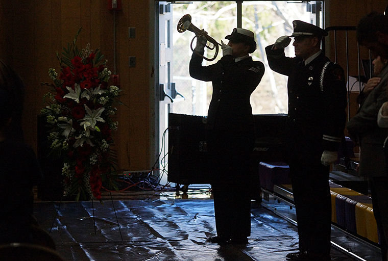 Members of the U.S. Navy Honor Guard perform during a memorial service for Robert "Moe" Moser Saturday, Feb. 21 at Quilcene School. Photo by Nicholas Johnson