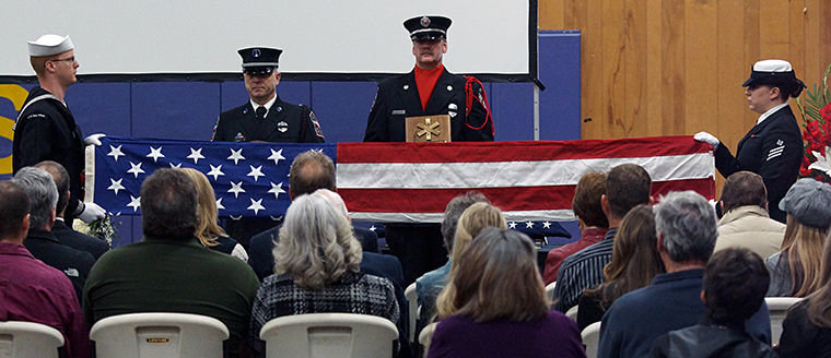 Members of the U.S. Navy Honor Guard present the colors during a memorial service for Robert "Moe" Moser Saturday, Feb. 21 at Quilcene School. Photo by Nicholas Johnson
