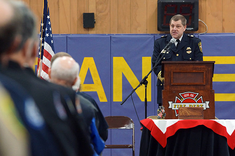 Quilcene Fire Chief Larry Karp talks about Robert "Moe" Moser at a memorial service Saturday, Feb. 21 at Quilcene School. Photo by Nicholas Johnson
