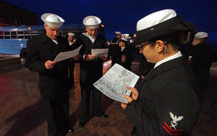 Melanie Ricardo, right, of the USS John C. Stennis looks over a map of Port Townsend provided by Jefferson County Chamber of Commerce employees with fellow sailors moments after stepping off a school bus at Pope Marine Park downtown. Ricardo and several others were part of a shore patrol whose mission was walk about town in uniform keeping an eye on plain-clothed sailors enjoying a night out. Photo by Nicholas Johnson