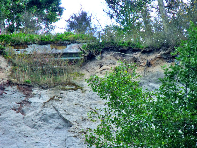 This is the "End of the World" concrete casement as seen from the beach, courtesy of a zoom lens. Note how the concrete is becoming more exposed. Similar erosion has toppled concrete at Fort Flagler State Park on Marrowstone Island, and also threatens several locations at nearby Fort Worden State Park. Photo by Steven Johnson