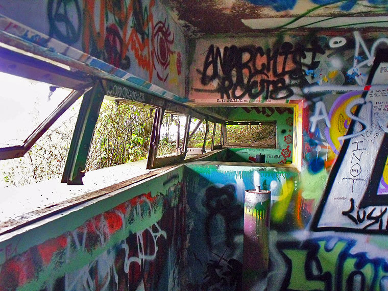 Two rooms with a view, two rooms with walls covered with colorful graffiti. This Tibbals Hill observation position from 1941 held spotting equipment for artillery range finders connected to a cannon battery at nearby Fort Worden. Photo by Steven Johnson