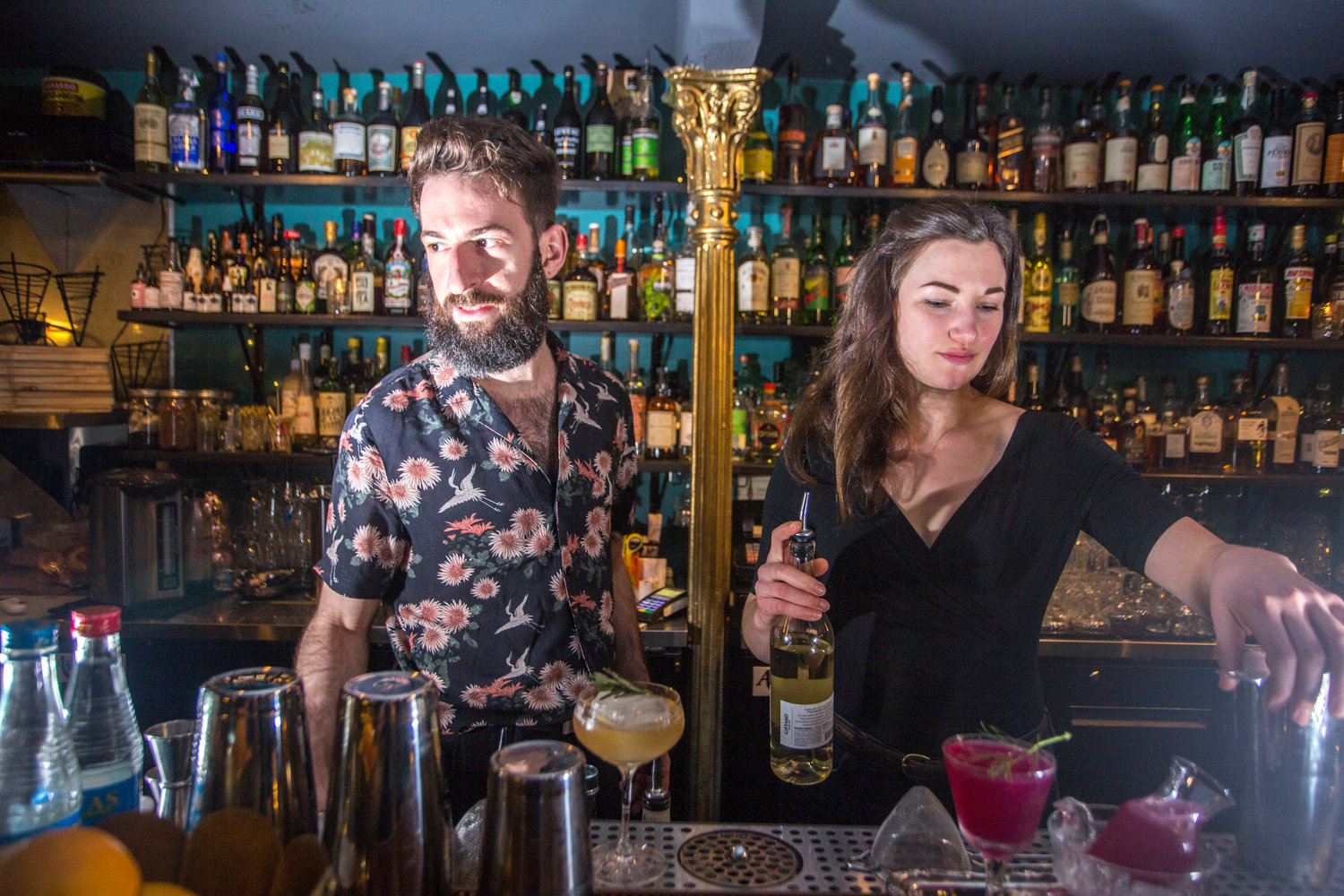 When sipping a cocktail crafted by Alexander Moats, left, or Sophia Elan, co-managers of The In Between, consumers are encouraged to enjoy the flavor and be transported to distant places and long-forgotten memories.