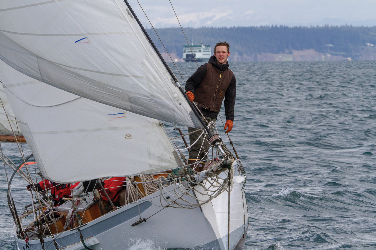 Chad Hedlund, a student at the Northwest School of Wooden Boat Building, sails for the first time with Bertram Levy on his boat Able.