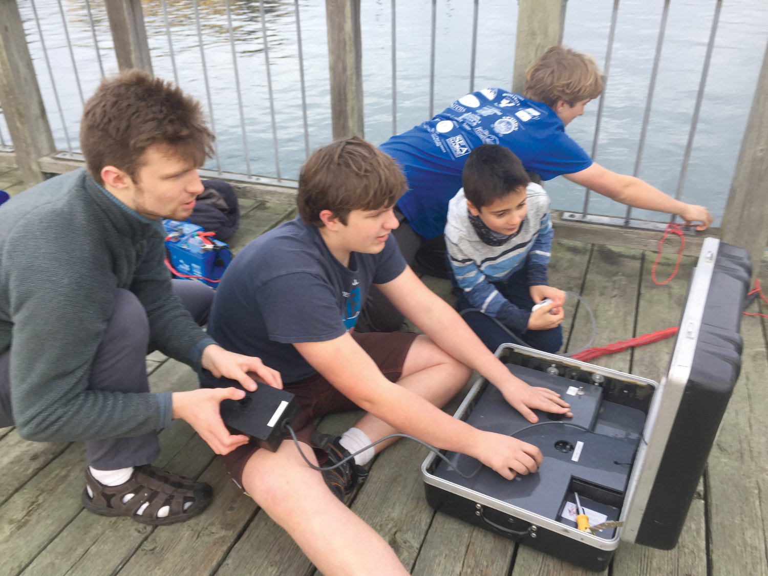 The team placed fourth at the national underwater ROV competition, partly due to their ability to work seamlessly together. Senior Logan Flanagan, ninth-grader Nathaniel Ashford, sixth-grader Ayden Ratliff and seventh-grader Everest Ashford all work in tandem during a saltwater test of their ROV in Port Townsend Bay.