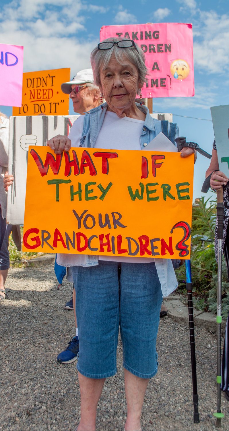 Lillian Lovato of Marrowstone Island displays her sign which was echoed in a chant: “Their children are our children.”