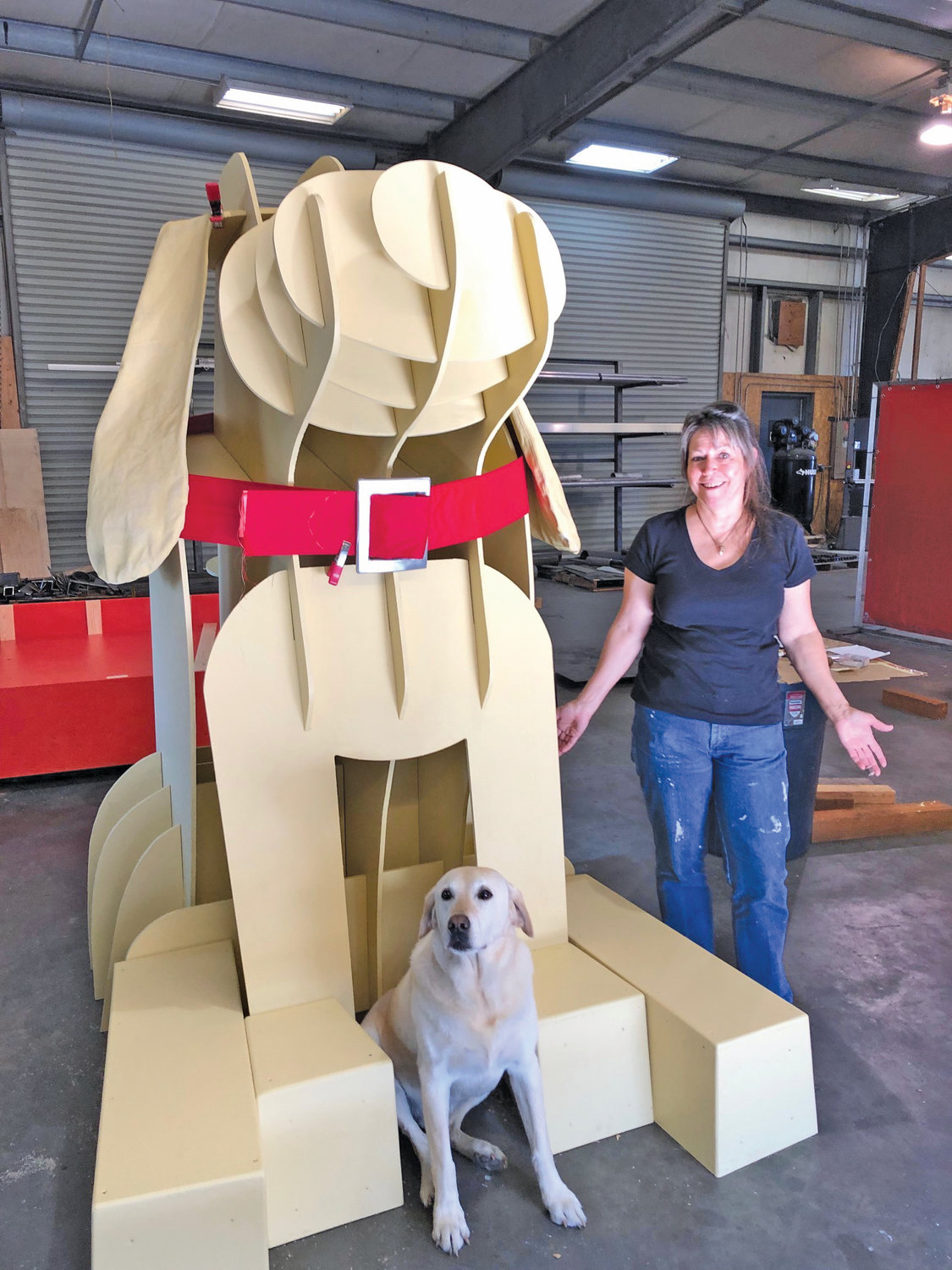 Yacht interior designer Gwendolyn Tracy working right up to the last minute with the model "Blazer" and the sculpture. Tracy supplied the collar and found a Boat Haven craftsman to produce the buckle.