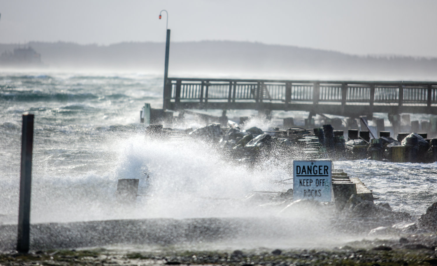Waves crash over the Point Hudson jetty, which is in disrepair, during last year’s memorable wind storm that coincided with a king tide on Dec. 20, 2018.
