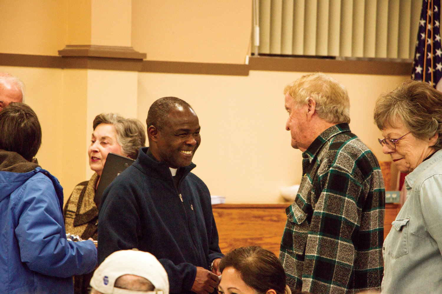 Father Peter Adoko-Enchill chats with church members during his farewell from St. Mary Star of the Sea Nov. 26.