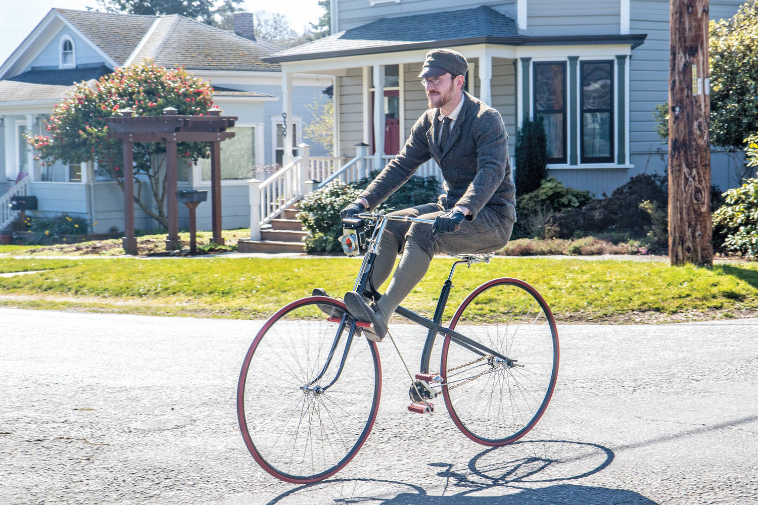 Gabriel Chrisman is an archivist, librarian and historian who specializes in Victorian-era technology such as bicycles. He has created an 1880s historical replica of a hard tire cross-frame safety bike to be used as a prop in a new period drama on HBO. Here, he coasts down a hill on the “safety bike,” using the coasting pedals that allowed riders to rest their feet while the pedals still turned.
