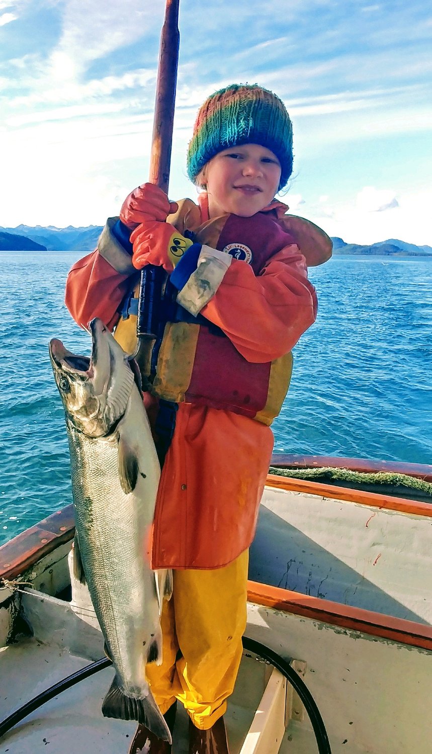 Ayla Moore holds up a coho salmon she managed haul in.