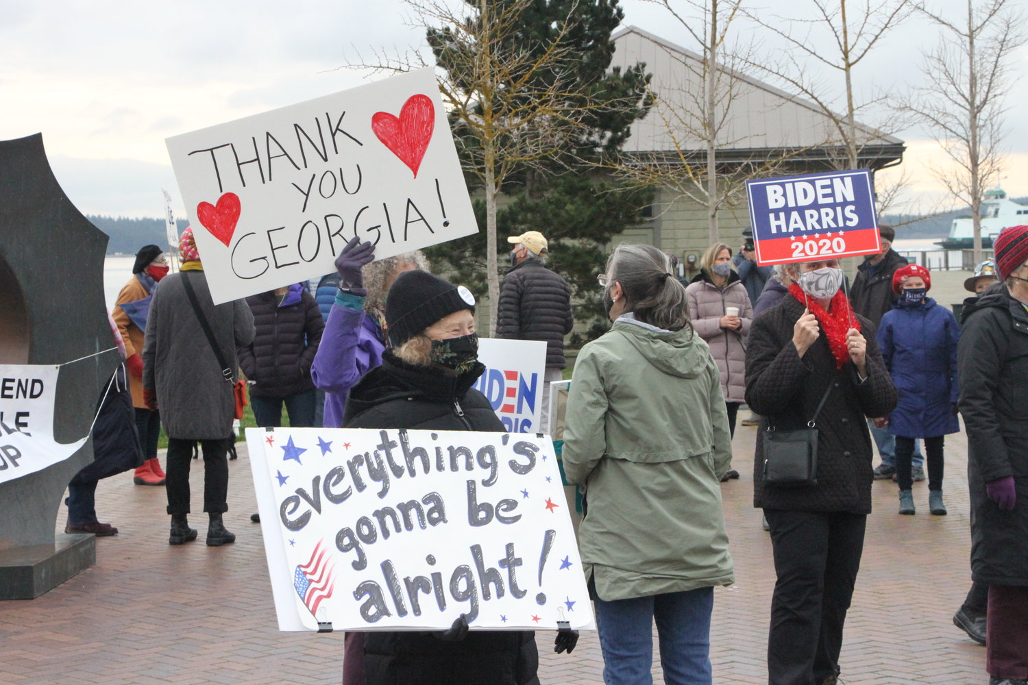 Demonstrators show their support for President Joe Biden and Vice President Kamala Harris' inauguration on Wednesday at Pope Marine Park in Port Townsend