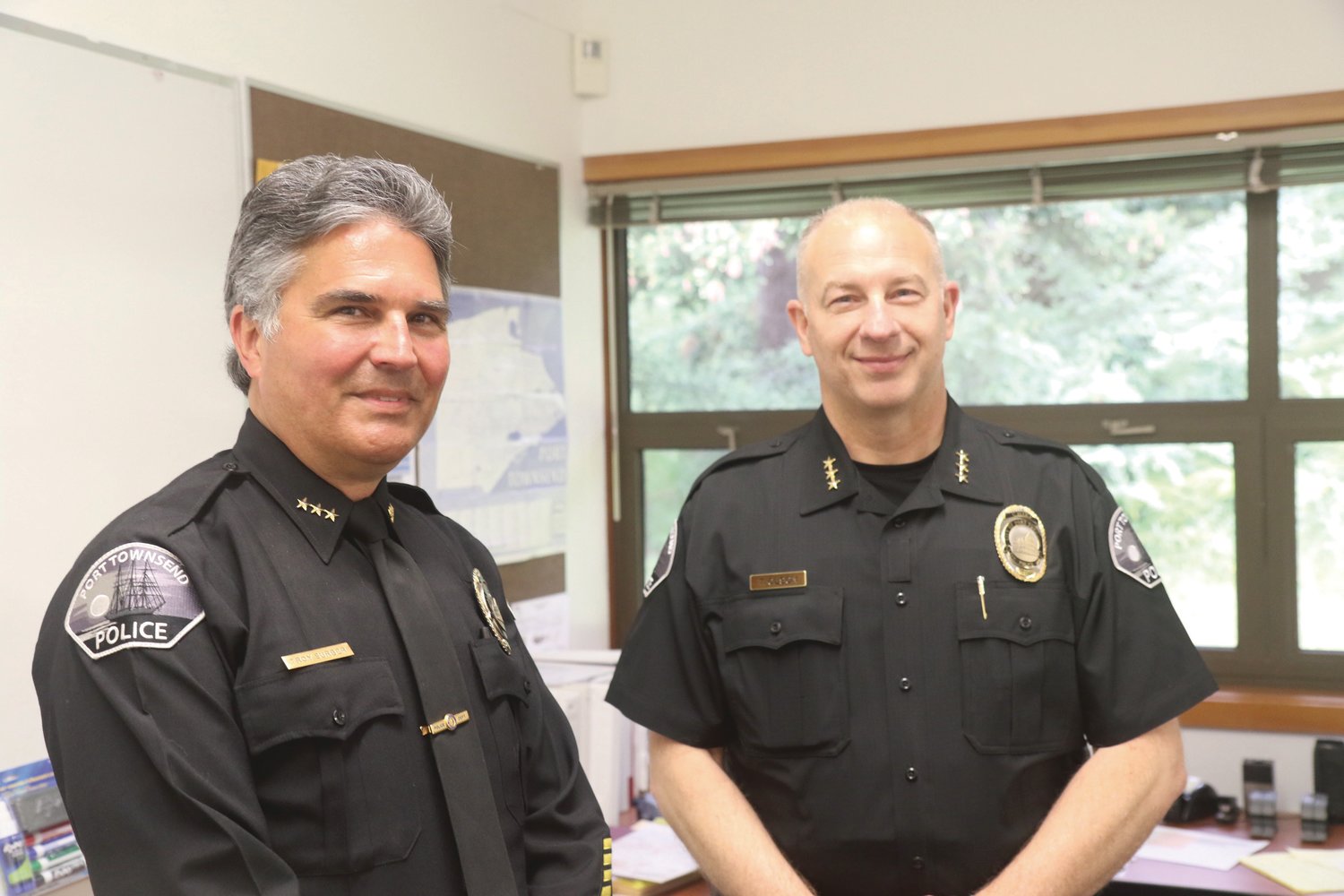 Outgoing Police Chief Troy Surber poses for a photo beside incoming Police Chief Thomas Olson on Surber’s last day with the department.