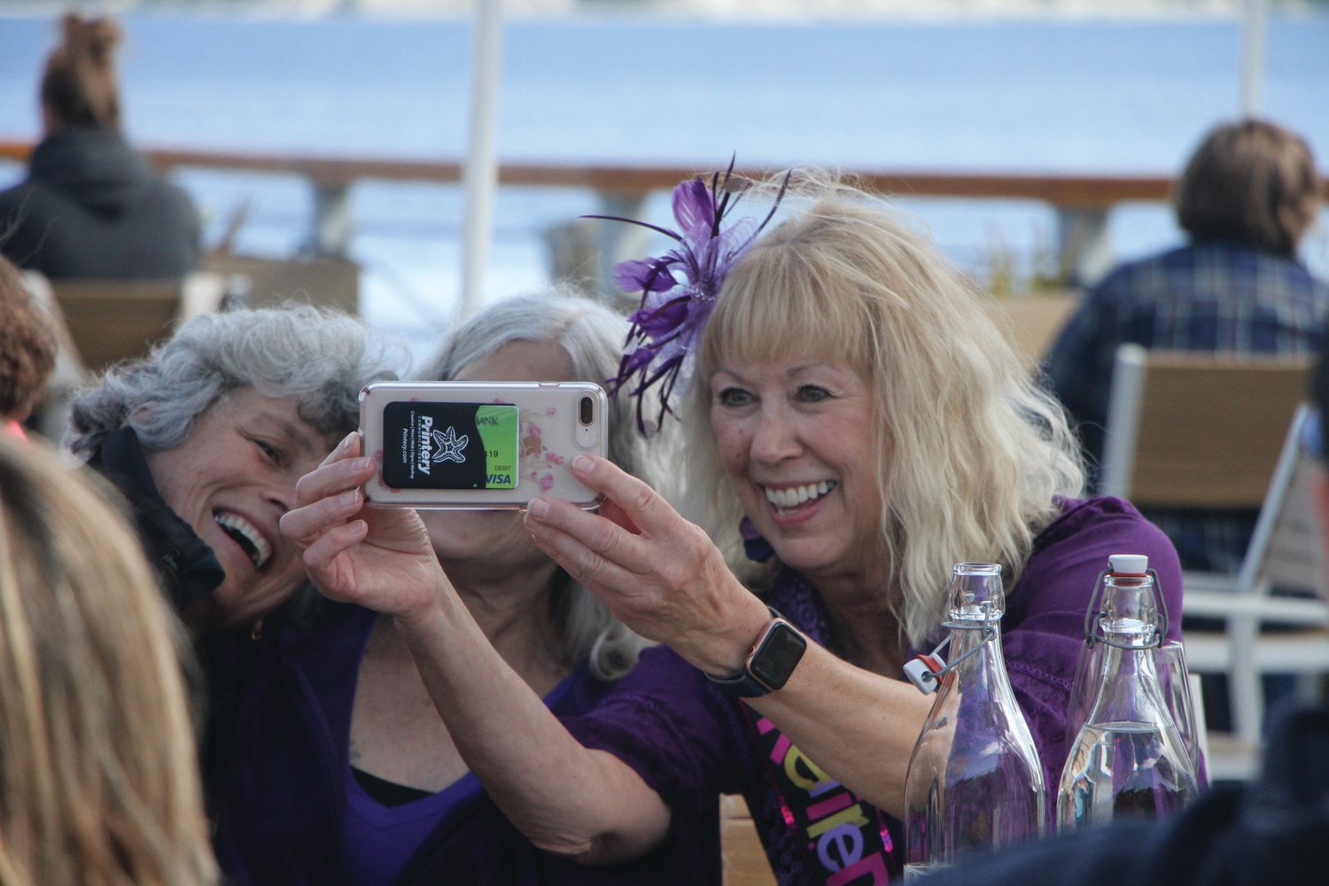 Jan Boutilier takes selfies with those who came to celebrate her retirement at Vintage by Port Townsend Vineyards.