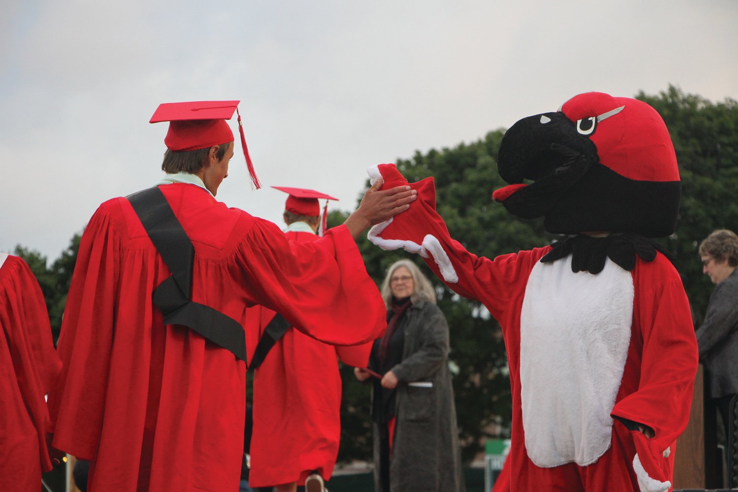 After giving the Redhawk mascot a high-five, students bounded across the stage for their diplomas.