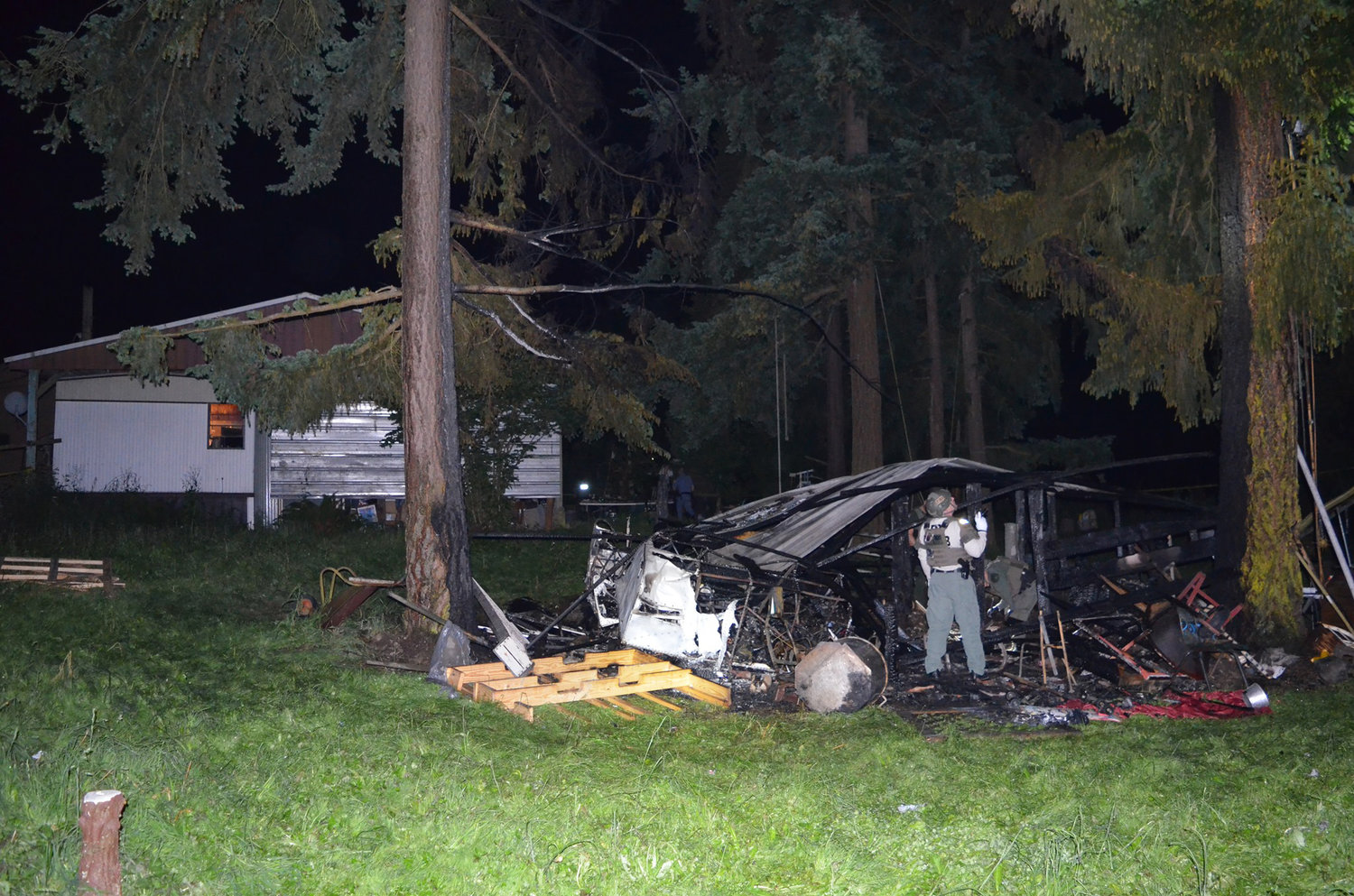 A bomb squad member examines the scene of an explosion in Port Hadlock Tuesday night.