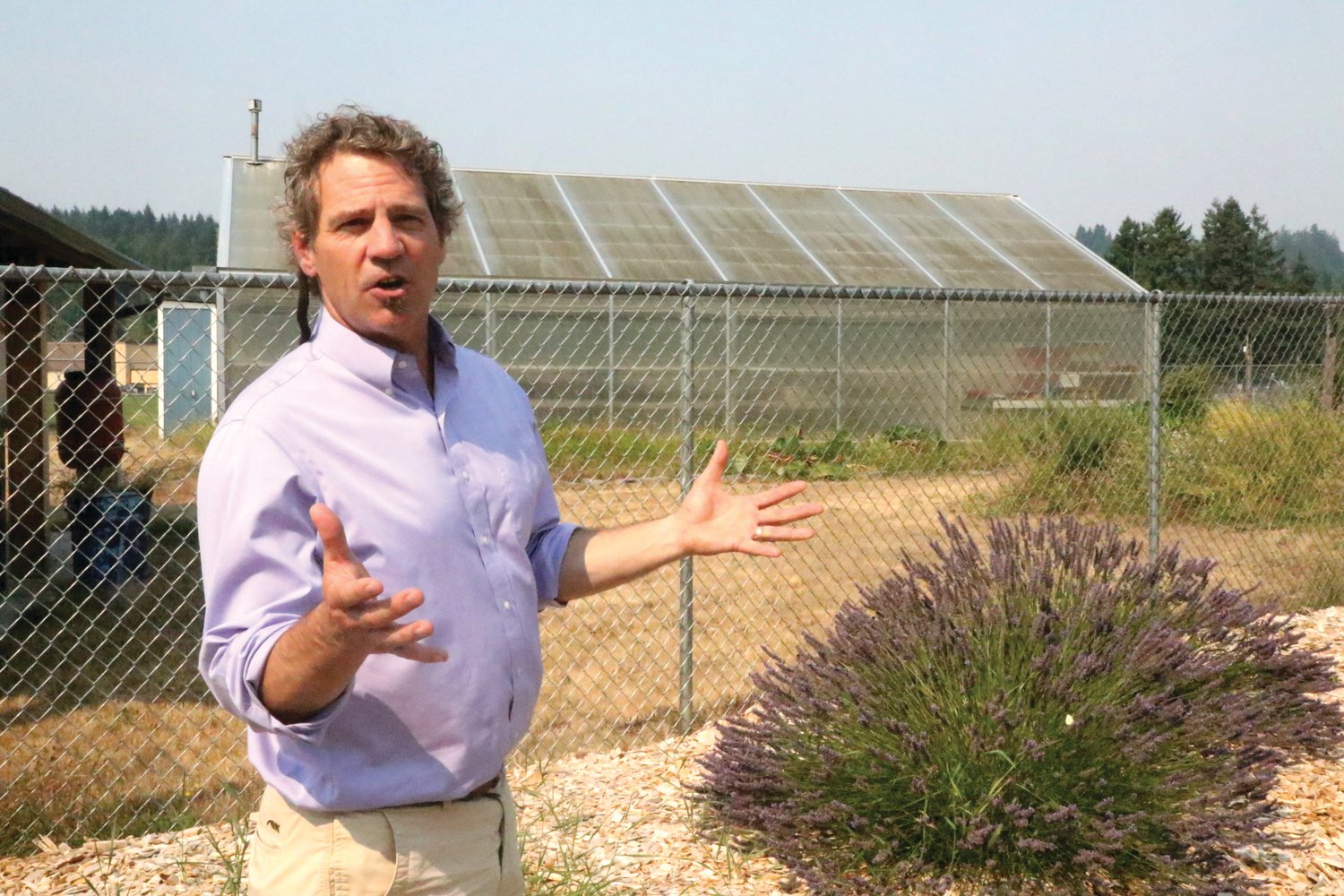 Superintendent Scott Mauk stands in front of one of the school’s greenhouses. All meals served at Chimacum schools are cooked from scratch and include produce grown on site.