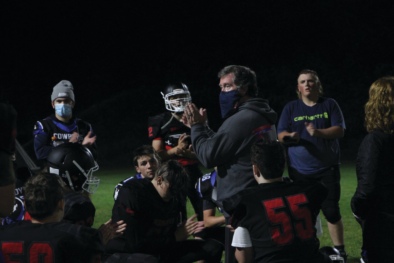 Rivals Head Coach Tony Haddenham speaks with his players after a home game during the football season.