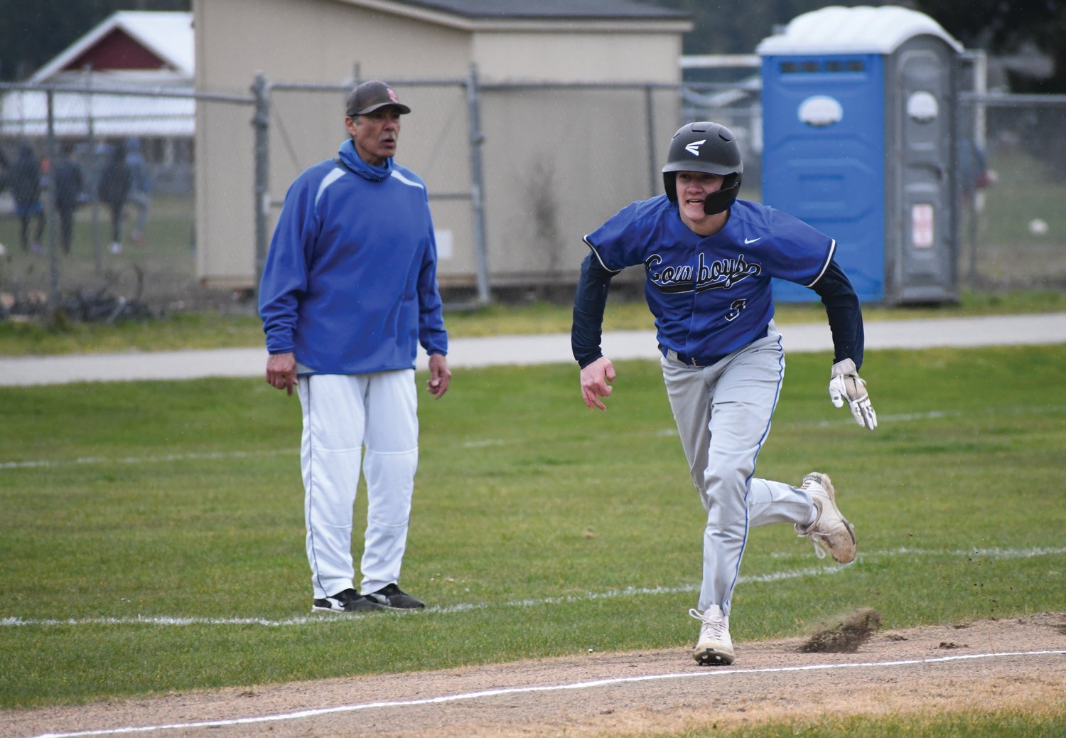Marcus Ritch of the Rivals rounds third base and sprints toward home plate to score a run.