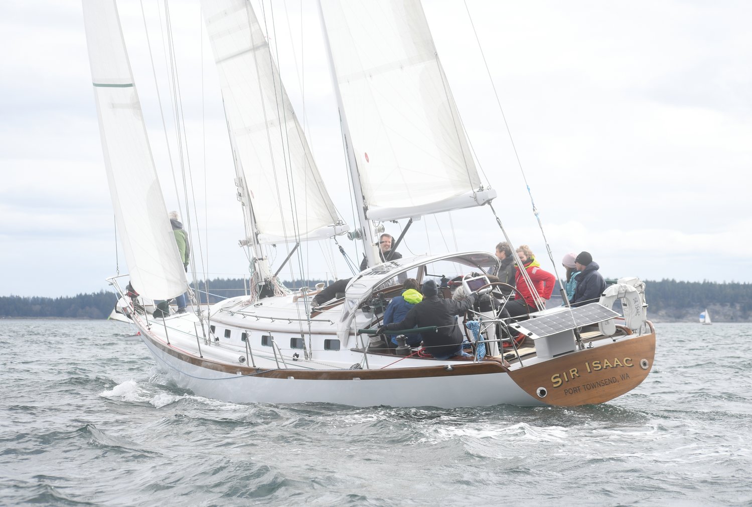 “Sir Isaac,” a stately 49-foot schooner owned and operated by locals Ann and John Bailey, races through the murky waters of Port Townsend Bay Saturday afternoon. The boat and crew placed first in the Racing Class for the 31st annual Shipwright’s Regatta sailboat race, winning the coveted Peg Leg trophy for a sublime performance at sea.
