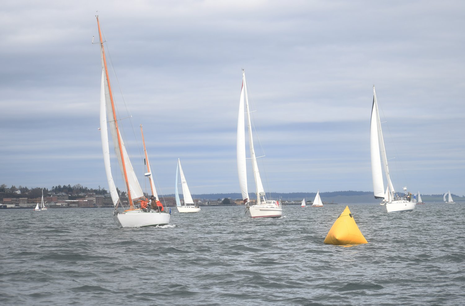 Rounding the Reach mark buoy near Boat Haven Marina, sailboats glide onwards in Shipwright’s Regatta race. A total of 35 boats participated in the event.