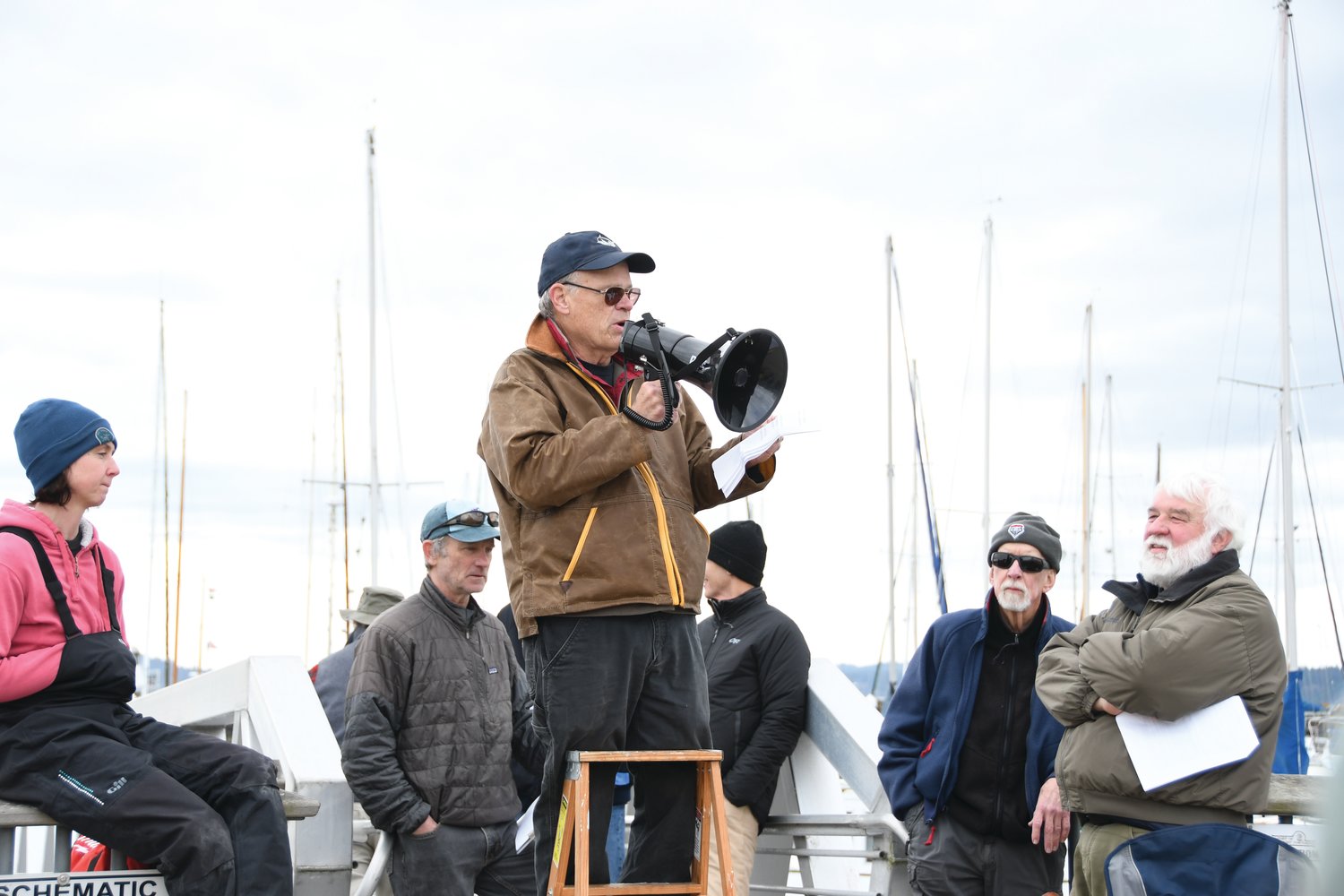 Jim Heumann, of the Shipwright’s Regatta, speaks to sailors at the Boat Haven A/B docks during the skipper’s meeting Saturday morning.